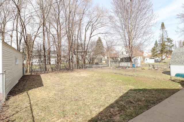 view of yard with a fenced backyard and a residential view