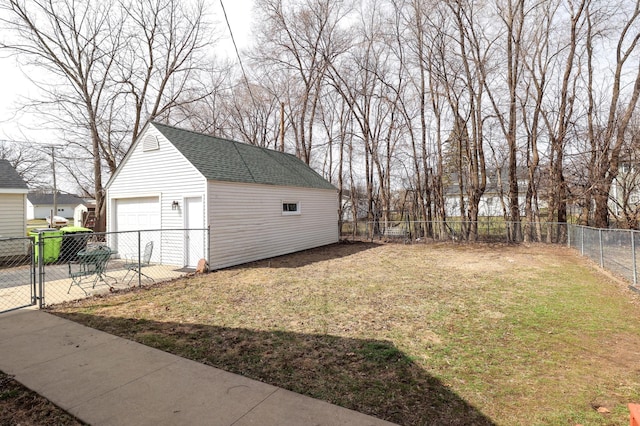 detached garage featuring a gate and fence