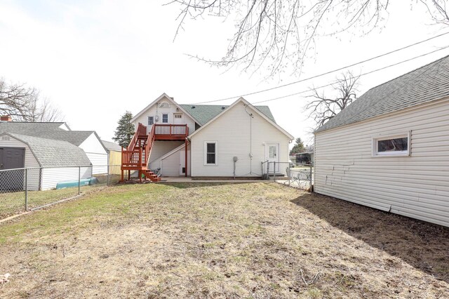 back of house with a storage shed, a fenced backyard, stairway, a deck, and an outdoor structure