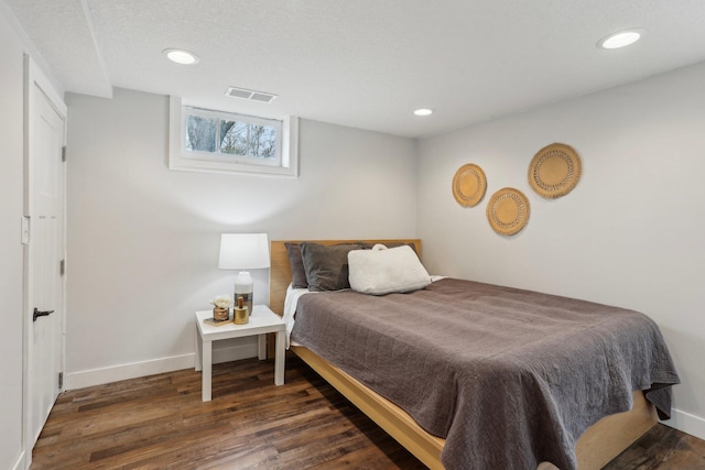 bedroom with recessed lighting, baseboards, visible vents, and wood finished floors