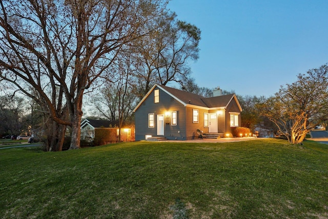 exterior space featuring a yard, a chimney, and entry steps