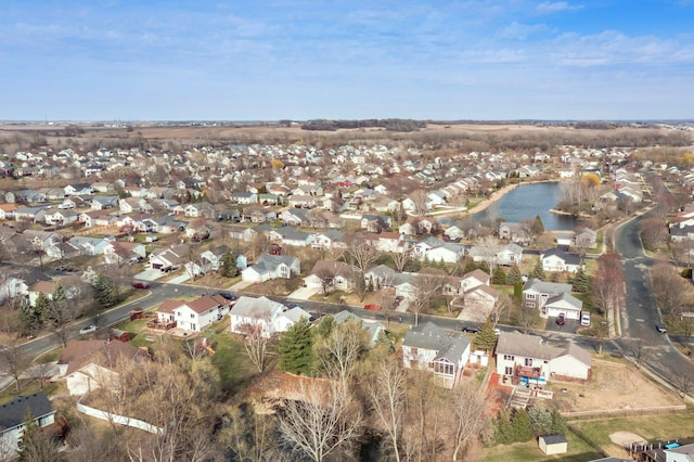 drone / aerial view featuring a water view and a residential view