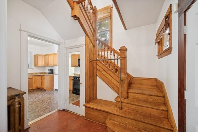 742 Laurel Ave, Saint Paul, MN 55104 - staircase featuring lofted ceiling and wood finished floors