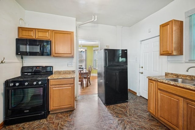742 Laurel Ave, Saint Paul, MN 55104 - kitchen with black appliances, brown cabinetry, a chandelier, and light stone countertops
