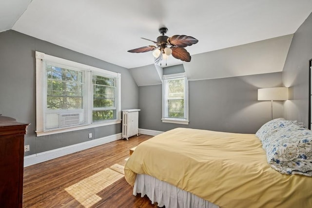 742 Laurel Ave, Saint Paul, MN 55104 - bedroom featuring vaulted ceiling, multiple windows, wood finished floors, radiator, and ceiling fan