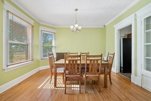 742 Laurel Ave, Saint Paul, MN 55104 - dining space with a chandelier, wood finished floors, and ornamental molding