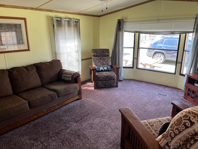 carpeted living room with visible vents and ornamental molding