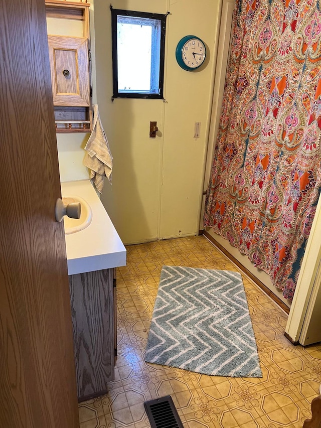 bathroom with tile patterned floors, visible vents, and vanity