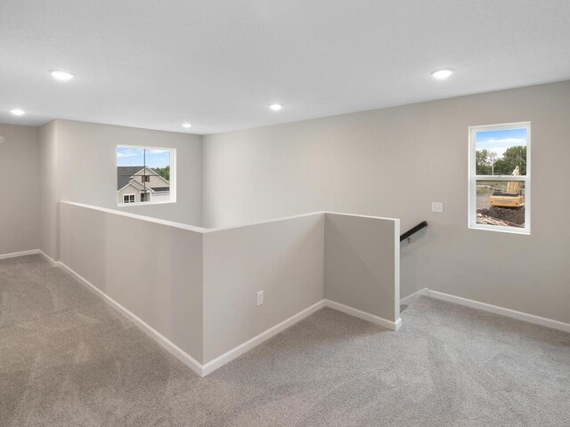 hallway with carpet floors, recessed lighting, and baseboards