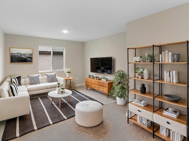 carpeted living room with baseboards