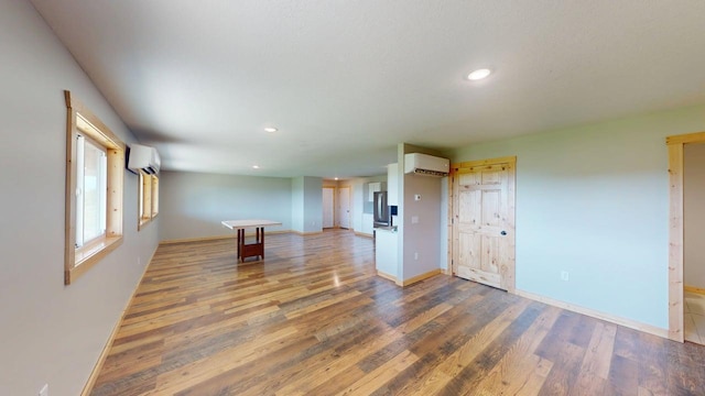 1950 228th Ln W, Mora, MN 55051 - spare room featuring a wall unit AC, wood finished floors, baseboards, and recessed lighting