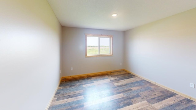 1950 228th Ln W, Mora, MN 55051 - empty room featuring wood finished floors, baseboards, and recessed lighting