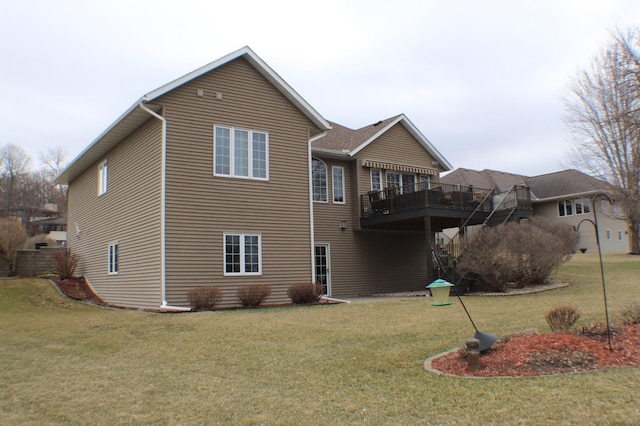 back of property with a lawn and a deck