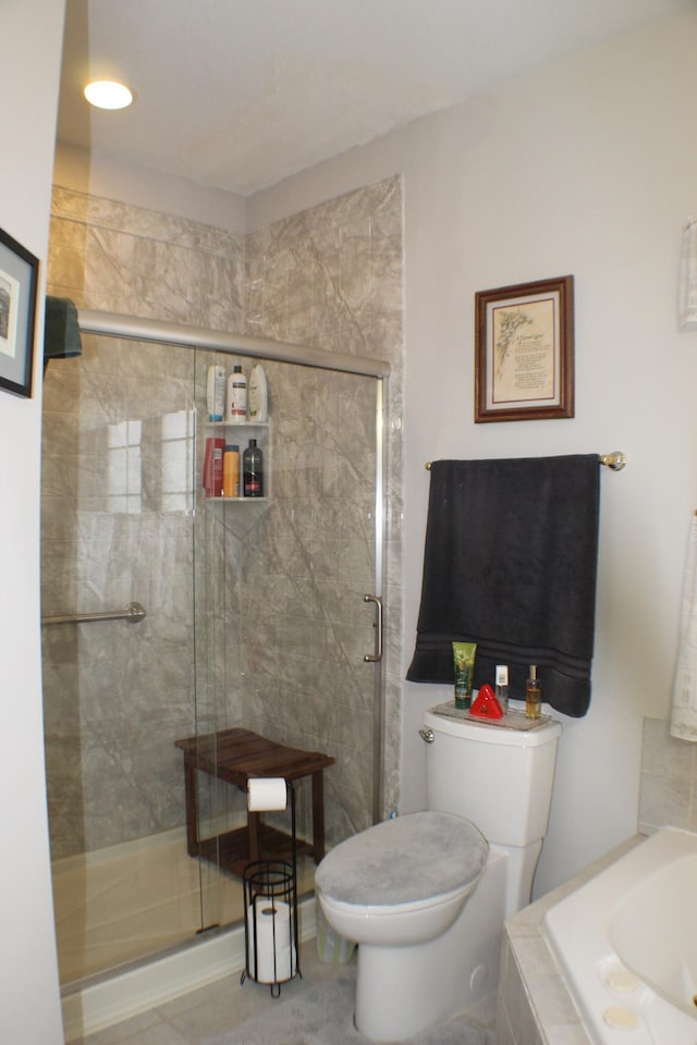 full bathroom with a bathtub, toilet, and a shower stall