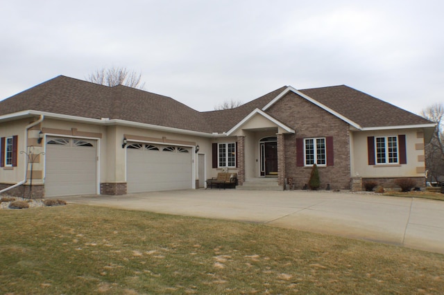 view of front of home with a garage, driveway, and a shingled roof