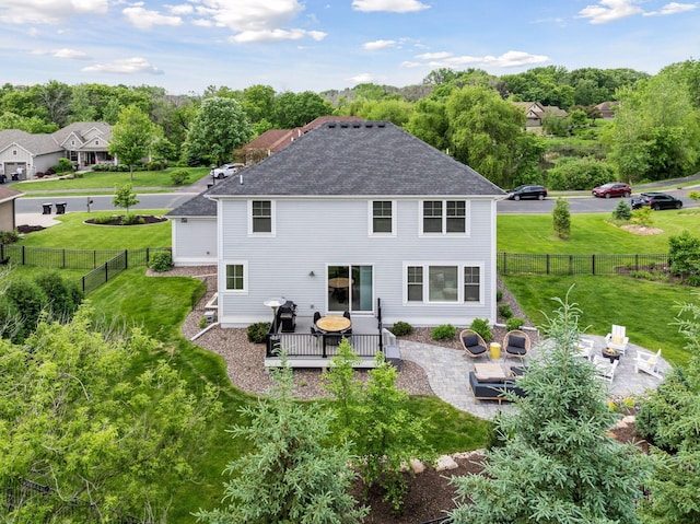 4528 Fable Hill Pkwy N, Hugo, MN 55038 - back of property with a patio area, a shingled roof, and a wooden deck