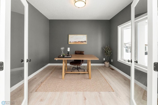 8851 Northern Lights Ave, Horace, ND 58047 - office area with baseboards, french doors, and light wood-type flooring