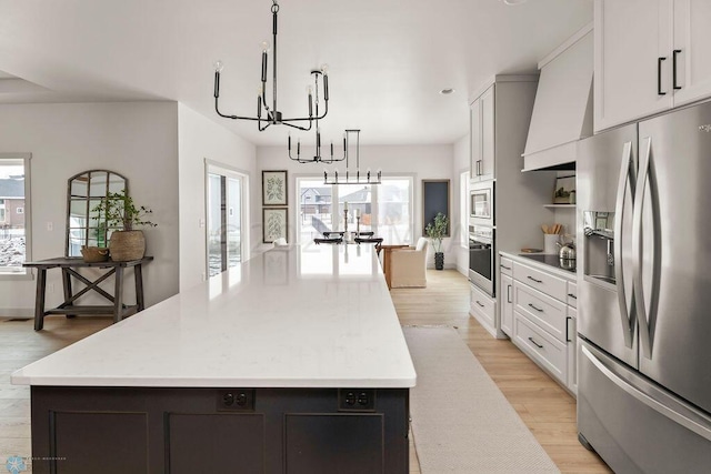 8851 Northern Lights Ave, Horace, ND 58047 - kitchen featuring a wealth of natural light, a notable chandelier, stainless steel appliances, and light wood finished floors