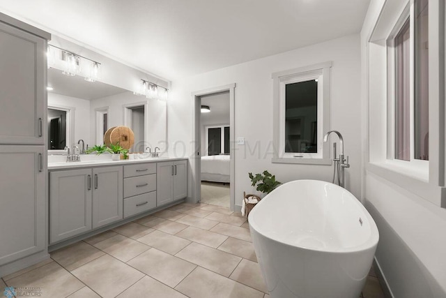 8851 Northern Lights Ave, Horace, ND 58047 - ensuite bathroom featuring a sink, double vanity, a freestanding tub, tile patterned flooring, and connected bathroom