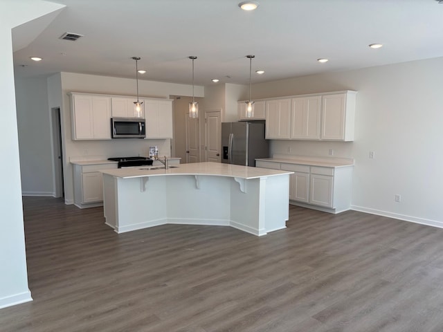 1755 Hauer Trl, Shakopee, MN 55379 - kitchen featuring appliances with stainless steel finishes, a sink, wood finished floors, white cabinets, and recessed lighting