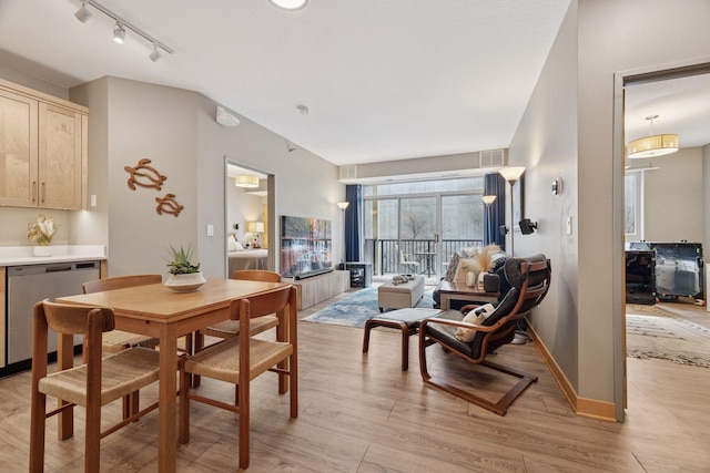 dining room with track lighting, visible vents, and light wood-style flooring