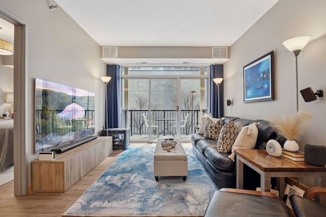 living area featuring visible vents and light wood-type flooring