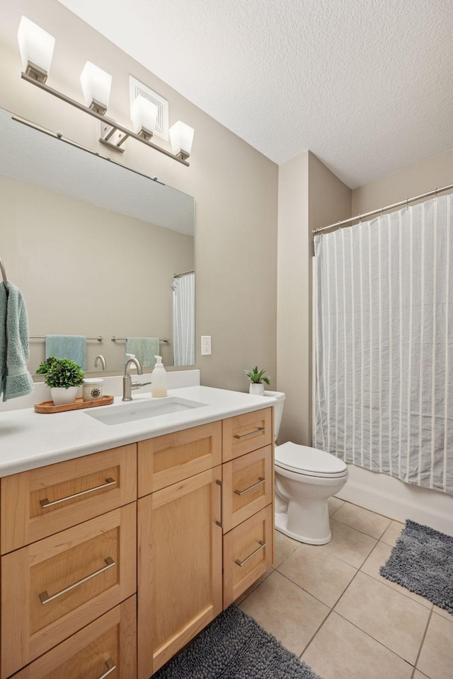 full bath with tile patterned flooring, shower / bathtub combination with curtain, toilet, vanity, and a textured ceiling