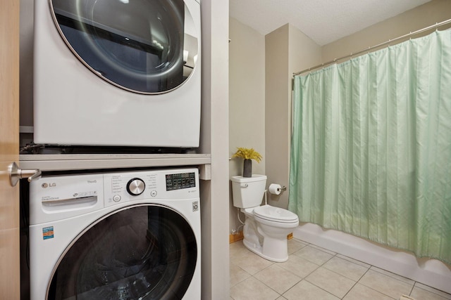full bath with toilet, shower / bath combination with curtain, stacked washer / drying machine, and tile patterned flooring