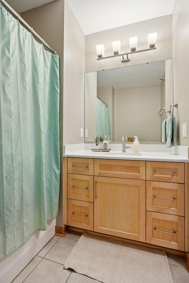 full bathroom with tile patterned floors, vanity, and shower / tub combo with curtain