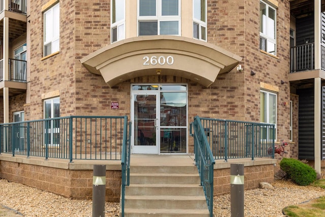 property entrance featuring brick siding