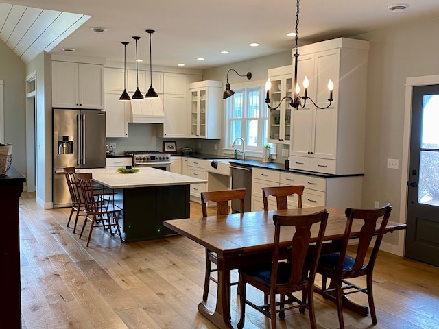 dining room featuring baseboards, recessed lighting, an inviting chandelier, and light wood-style floors