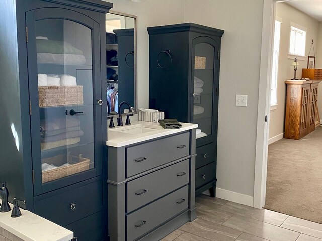 bathroom with vanity and baseboards