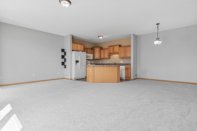 kitchen with open floor plan, baseboards, white appliances, and carpet flooring