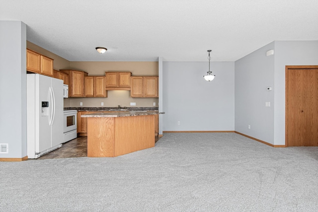 kitchen with a center island, carpet flooring, a sink, visible vents, and white appliances