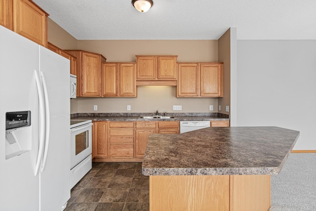 kitchen with a center island, a sink, a textured ceiling, dark countertops, and white appliances