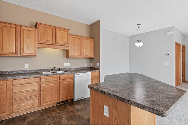 kitchen featuring a center island, a sink, dark countertops, dishwasher, and hanging light fixtures