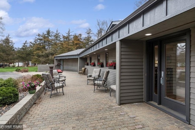 view of patio featuring a garage