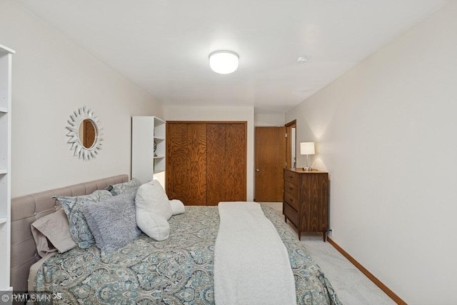 bedroom with light carpet and a closet