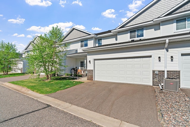 7371 Kalland Cir NE, Otsego, MN 55301 - view of front of property featuring asphalt driveway, brick siding, and central AC unit