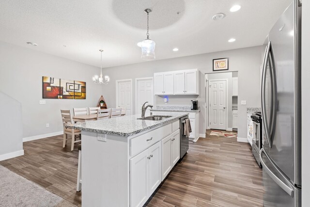 7371 Kalland Cir NE, Otsego, MN 55301 - kitchen with appliances with stainless steel finishes, a sink, baseboards, recessed lighting, and wood finished floors