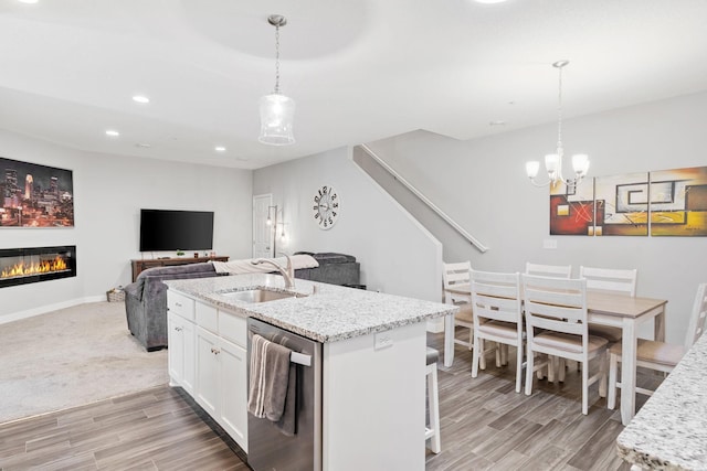 7371 Kalland Cir NE, Otsego, MN 55301 - kitchen with dishwasher, a sink, light wood-style flooring, white cabinetry, and light stone counters