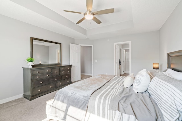 7371 Kalland Cir NE, Otsego, MN 55301 - bedroom with light colored carpet, a tray ceiling, baseboards, ceiling fan, and connected bathroom
