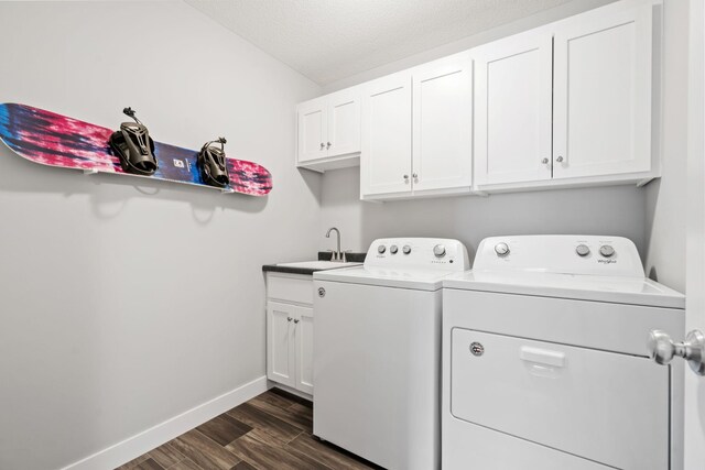 7371 Kalland Cir NE, Otsego, MN 55301 - laundry room with washer and dryer, cabinet space, dark wood finished floors, baseboards, and a textured ceiling