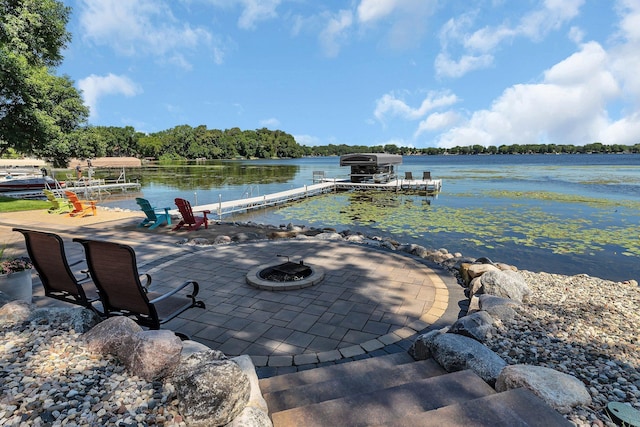 21008 654th Ave, Ellsworth Twp, MN 55355 - view of patio with a boat dock, an outdoor fire pit, and a water view