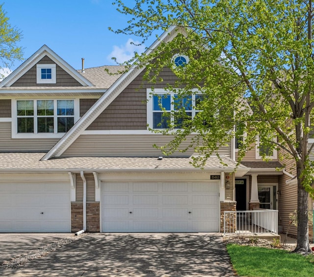 15463 June Grass Ln, Eden Prairie, MN 55347 - view of front facade featuring concrete driveway, a garage, and a shingled roof