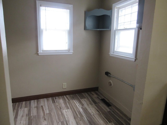empty room with baseboards and wood finished floors