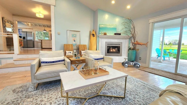 15151 304th St, Sumner Twp, MN 55975 - living room with recessed lighting, a glass covered fireplace, wood finished floors, and lofted ceiling