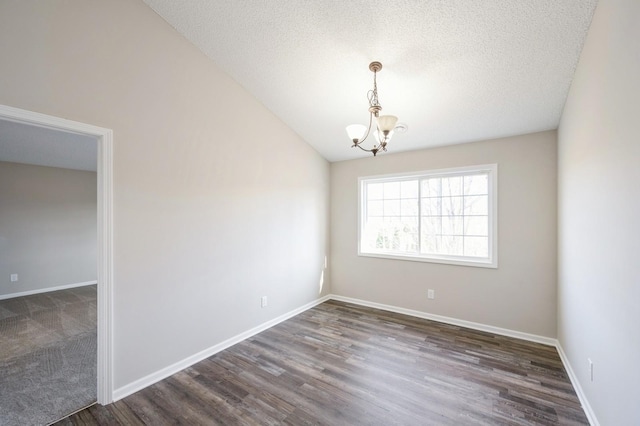 7615 Elm Grove Ave Unit 612, New Hope, MN 55428 - unfurnished room with vaulted ceiling, wood finished floors, baseboards, a textured ceiling, and a notable chandelier