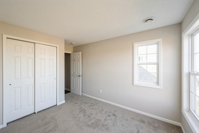7615 Elm Grove Ave Unit 612, New Hope, MN 55428 - unfurnished bedroom with a textured ceiling, carpet floors, a closet, and baseboards