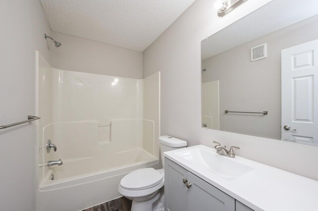 7615 Elm Grove Ave Unit 612, New Hope, MN 55428 - bathroom featuring a textured ceiling, shower / bathing tub combination, vanity, toilet, and visible vents